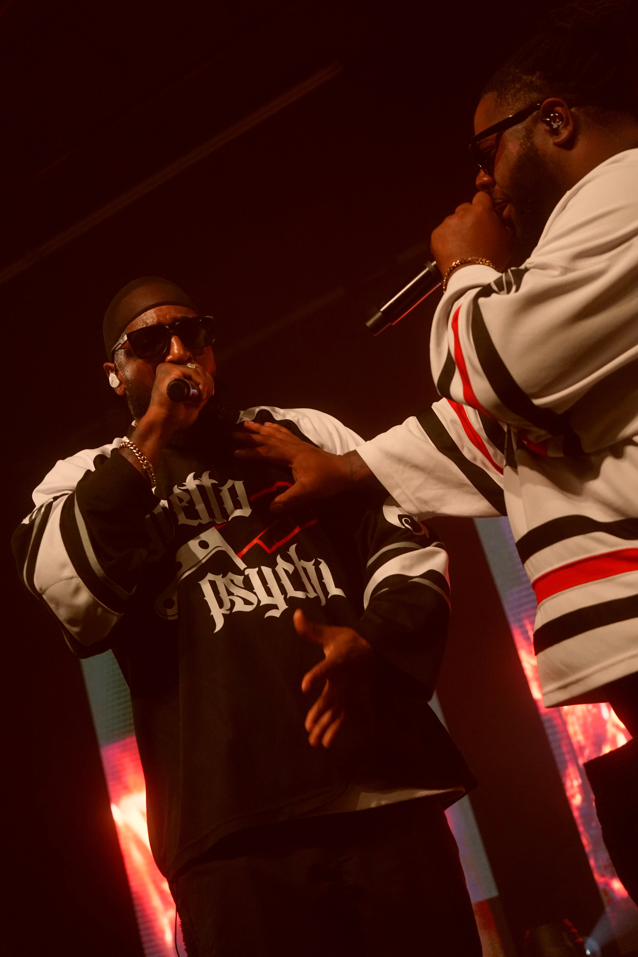 Two rappers on stage, one in Ghetto Psycho jersey