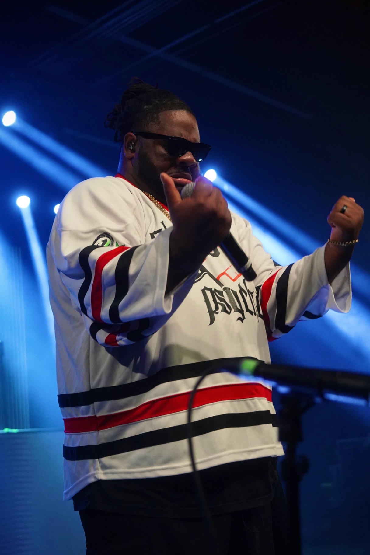 Performer in hockey jersey in blue light